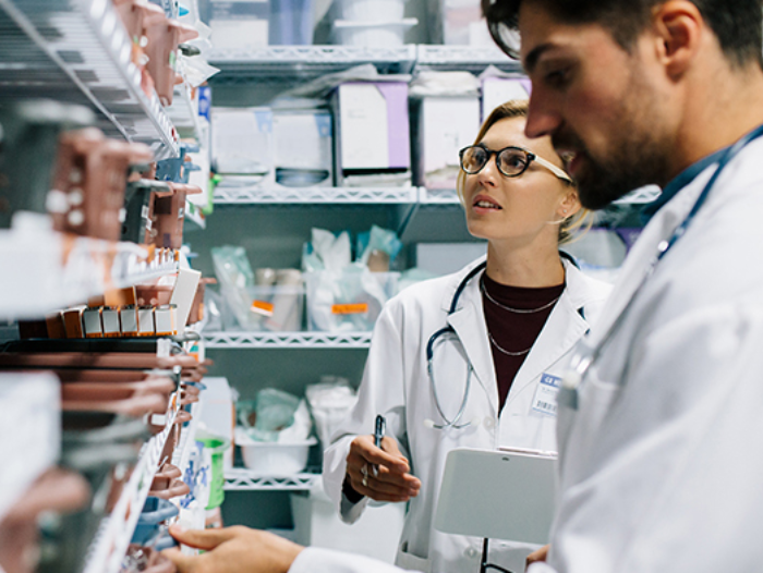 Pharmacists choosing and discussing medication